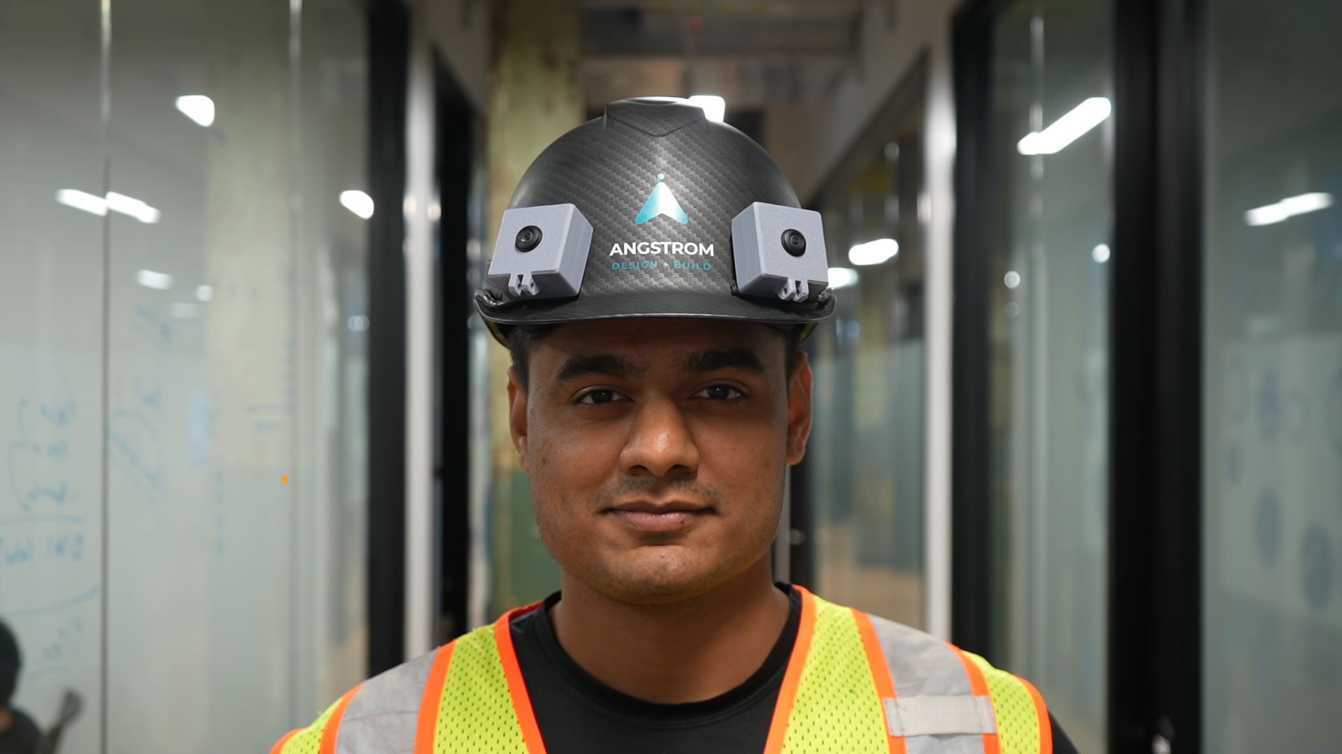 A worker wearing the scanning helmet with cameras mounted on each side
